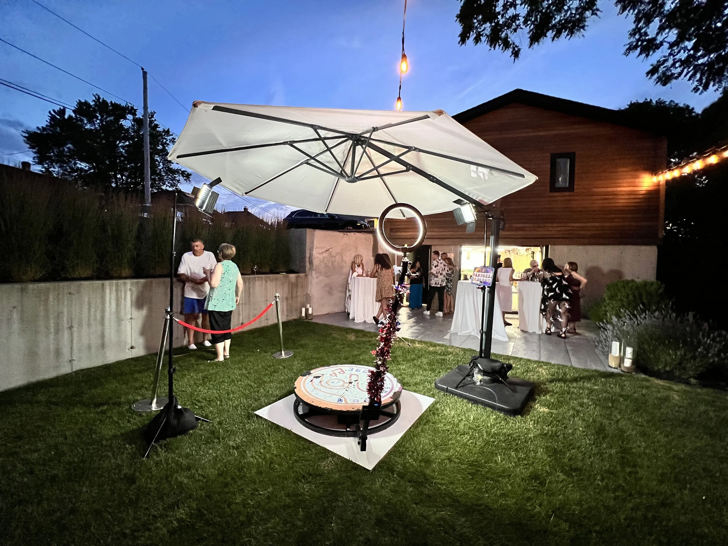 360-photo-booth-setup-with-spinning-wheel-and-guests-in-the-background
